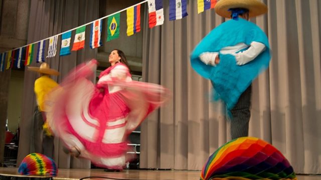 students dancing in costume at pan american days